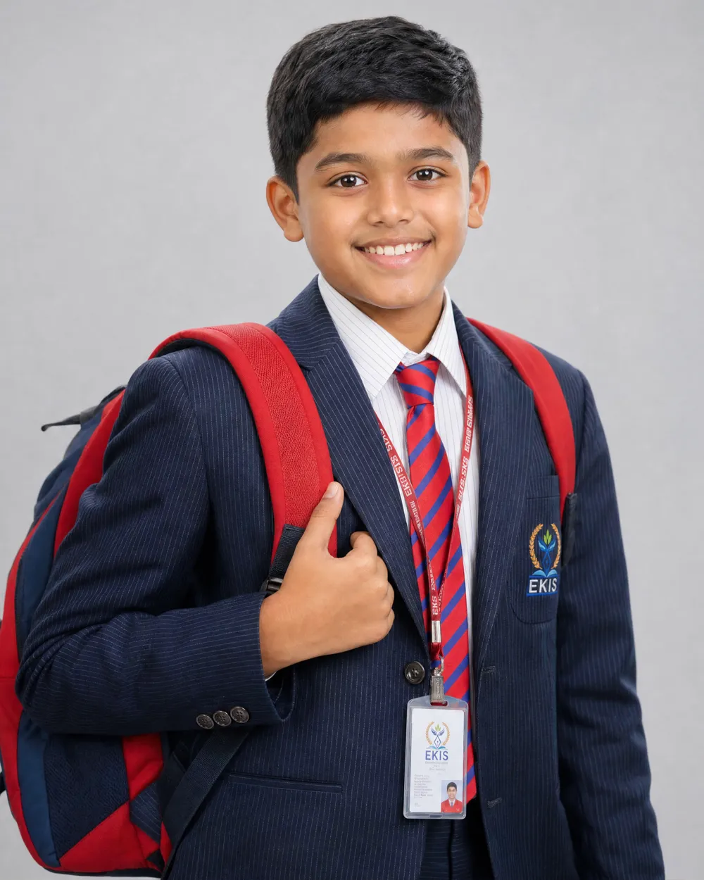 A primary-school student in EKIS uniform with a backpack