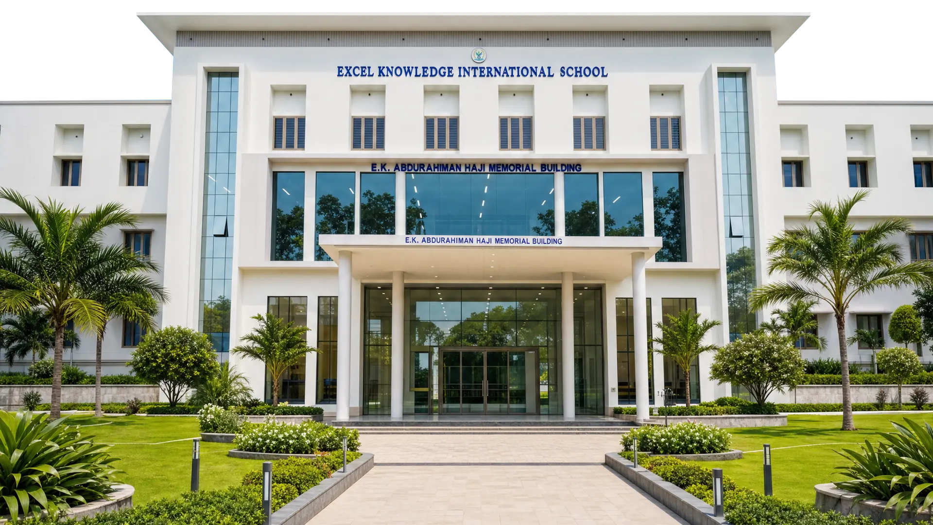 The front entrance of the EKIS school building framed by palms