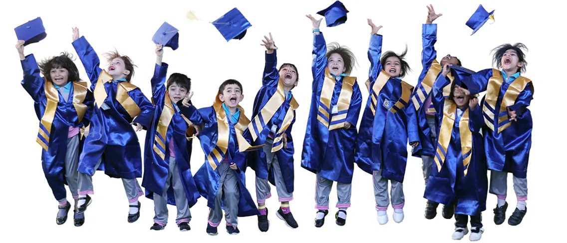 EKIS kindergarten children in blue graduation gowns, jumping and throwing their caps in the air