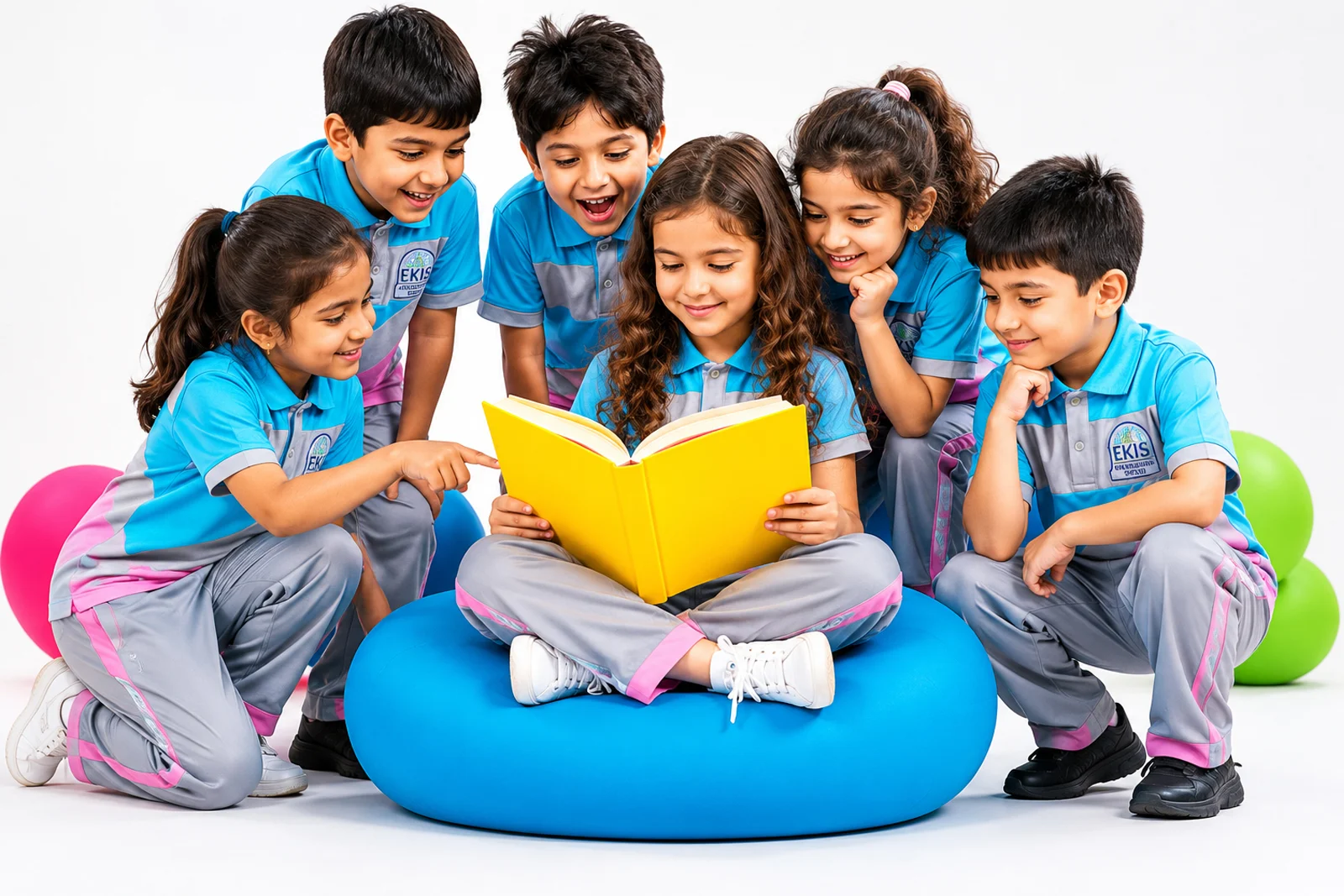 A group of young children in EKIS uniform reading a book together